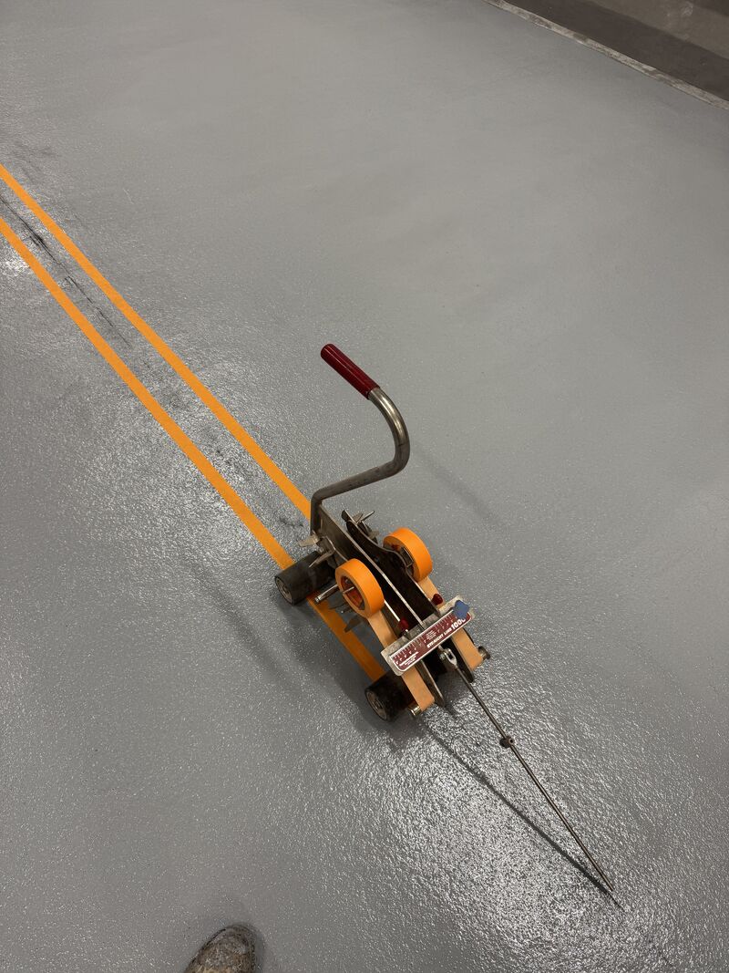 Durable 5S floor marking system integrated into SaniCrete STX resinous flooring, designed to withstand daily chemical washdowns, thermal cycling, and heavy forklift traffic in food processing plants