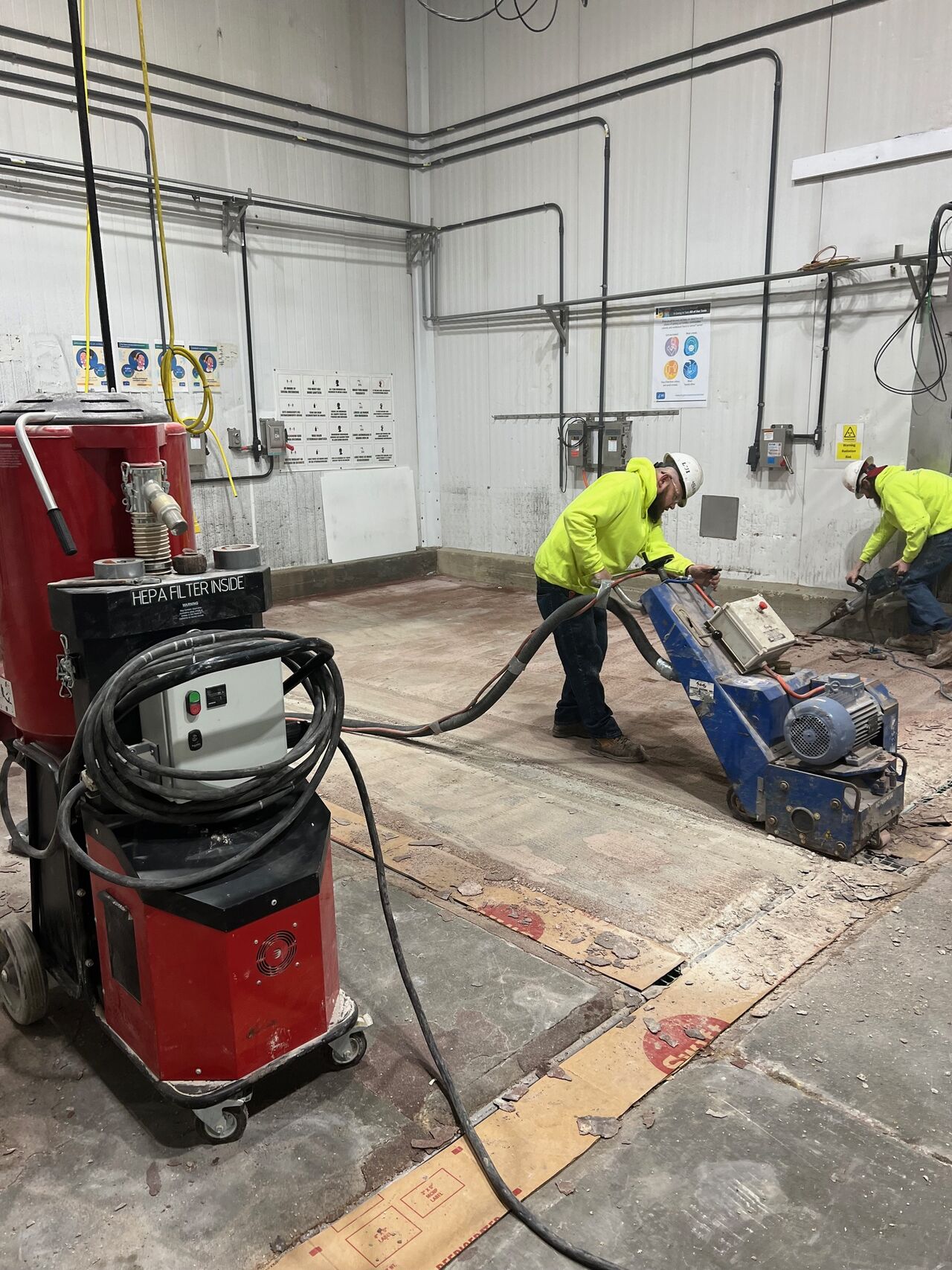 SaniCrete crew operating scarifier with HEPA vacuum to profile concrete substrate