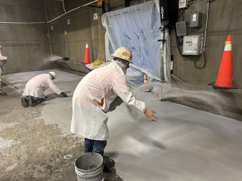Crew broadcasting aggregate into fresh SaniCrete STX in a blast freezer