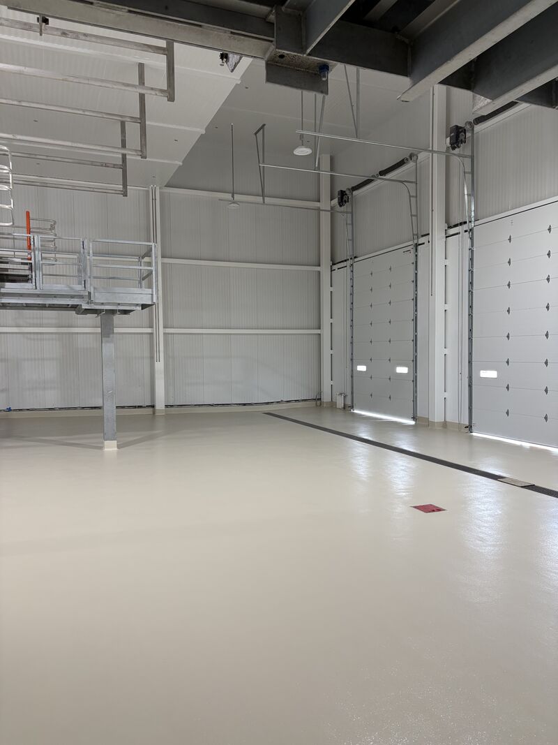 Close view of custom radius cove base detail in a dairy receiving bay