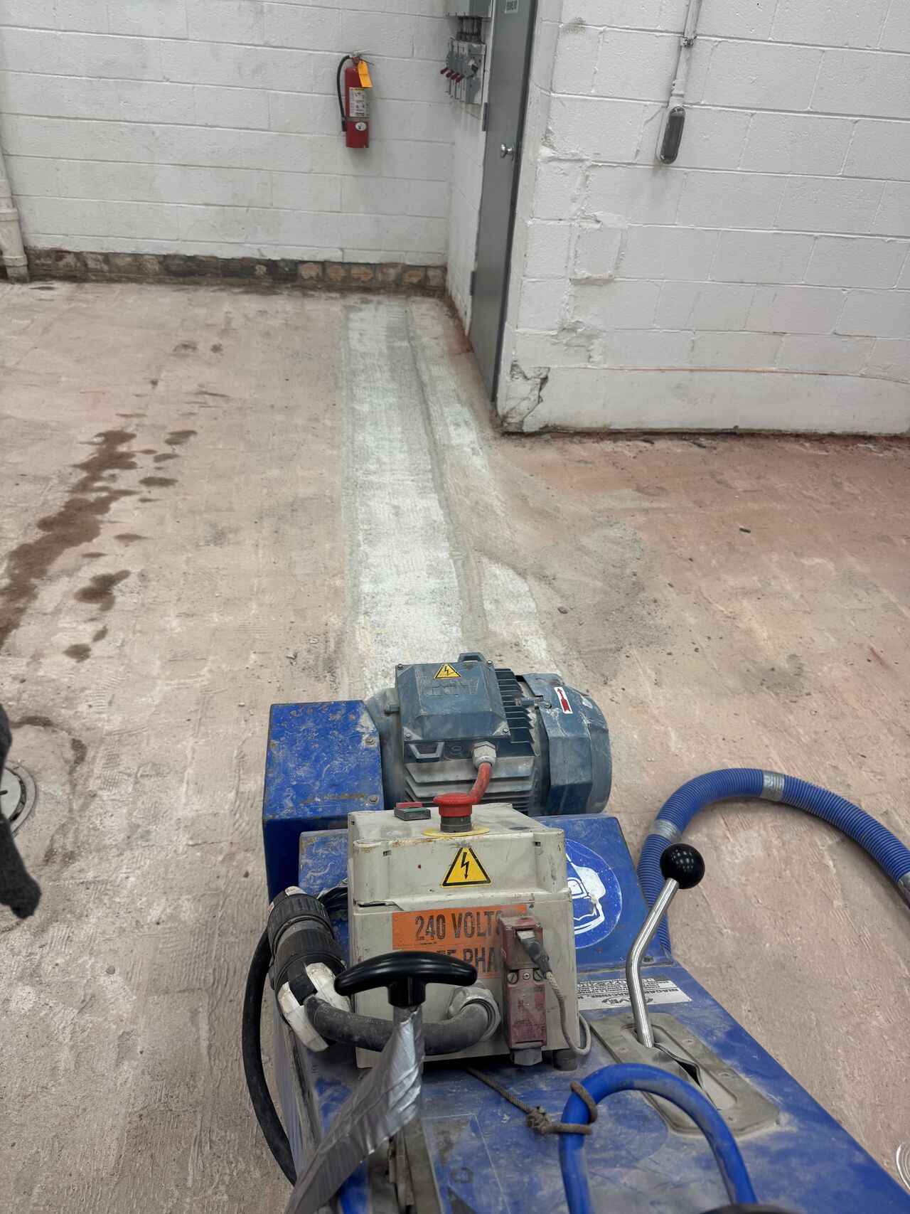 Scarifier profiling concrete substrate after dairy brick removal in dairy processing facility