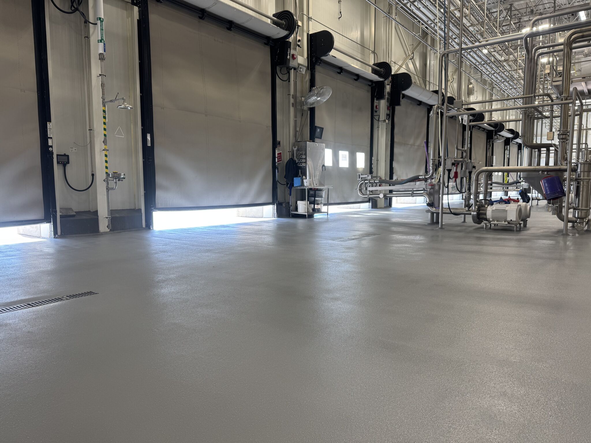 Finished SaniQuartz floor beside dairy production doors