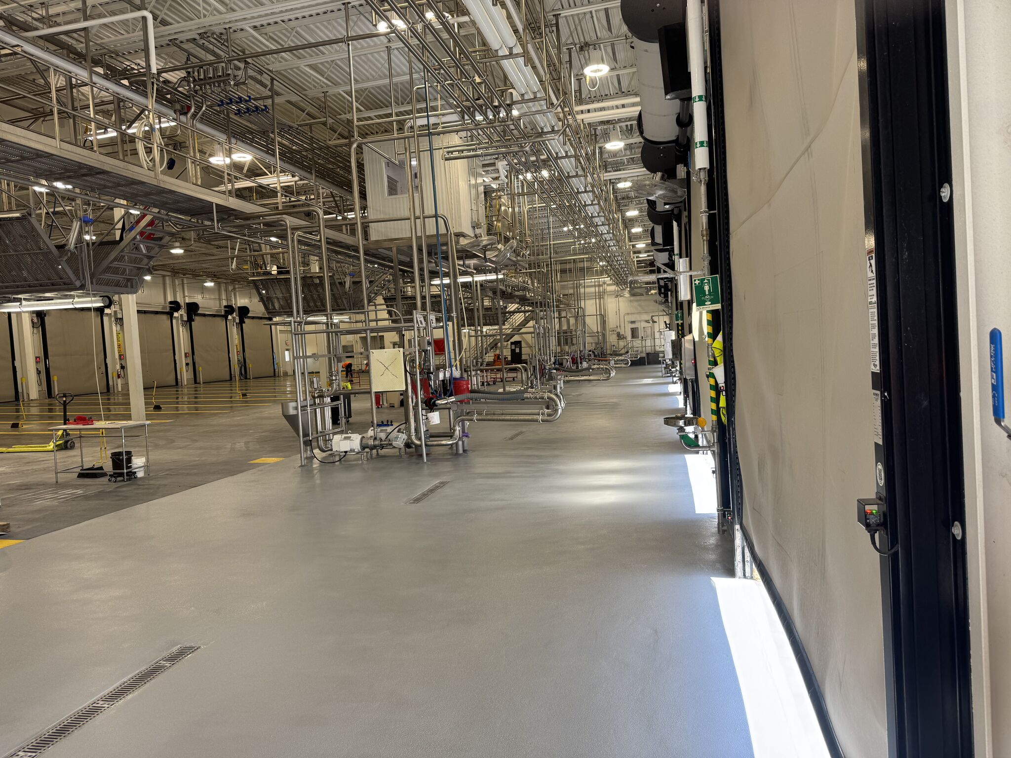 Finished SaniQuartz floor across a dairy production space after shutdown work