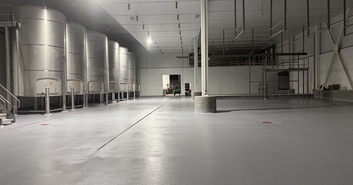 Finished gray floor in a new dairy processing area after a tornado passed the jobsite