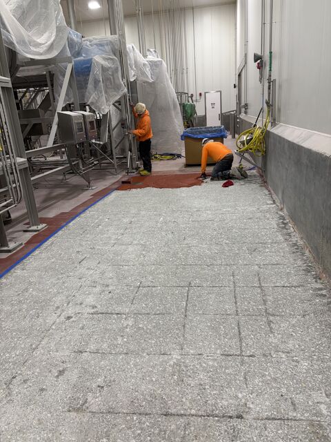 SaniCrete crew removing delaminated food plant flooring