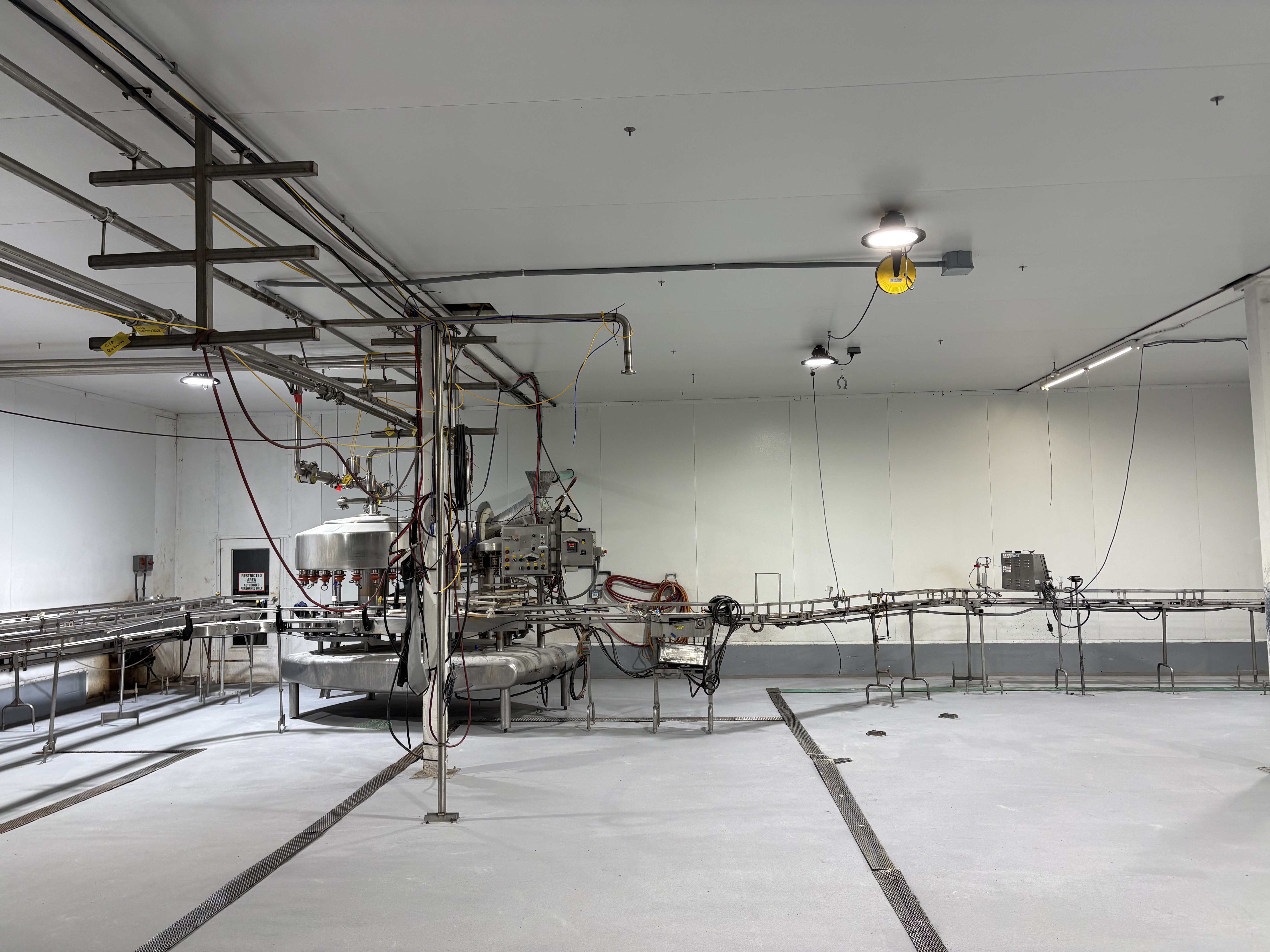 Completed bottling line floor with conveyor system and new SaniCrete flooring