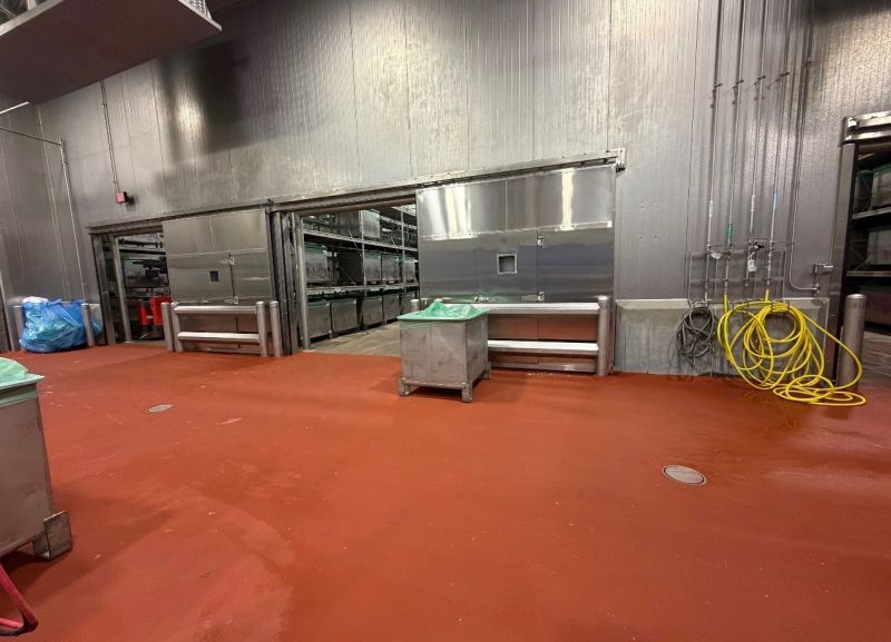 Finished red SaniCrete STX floor in a meat processing room after a Labor Day weekend installation
