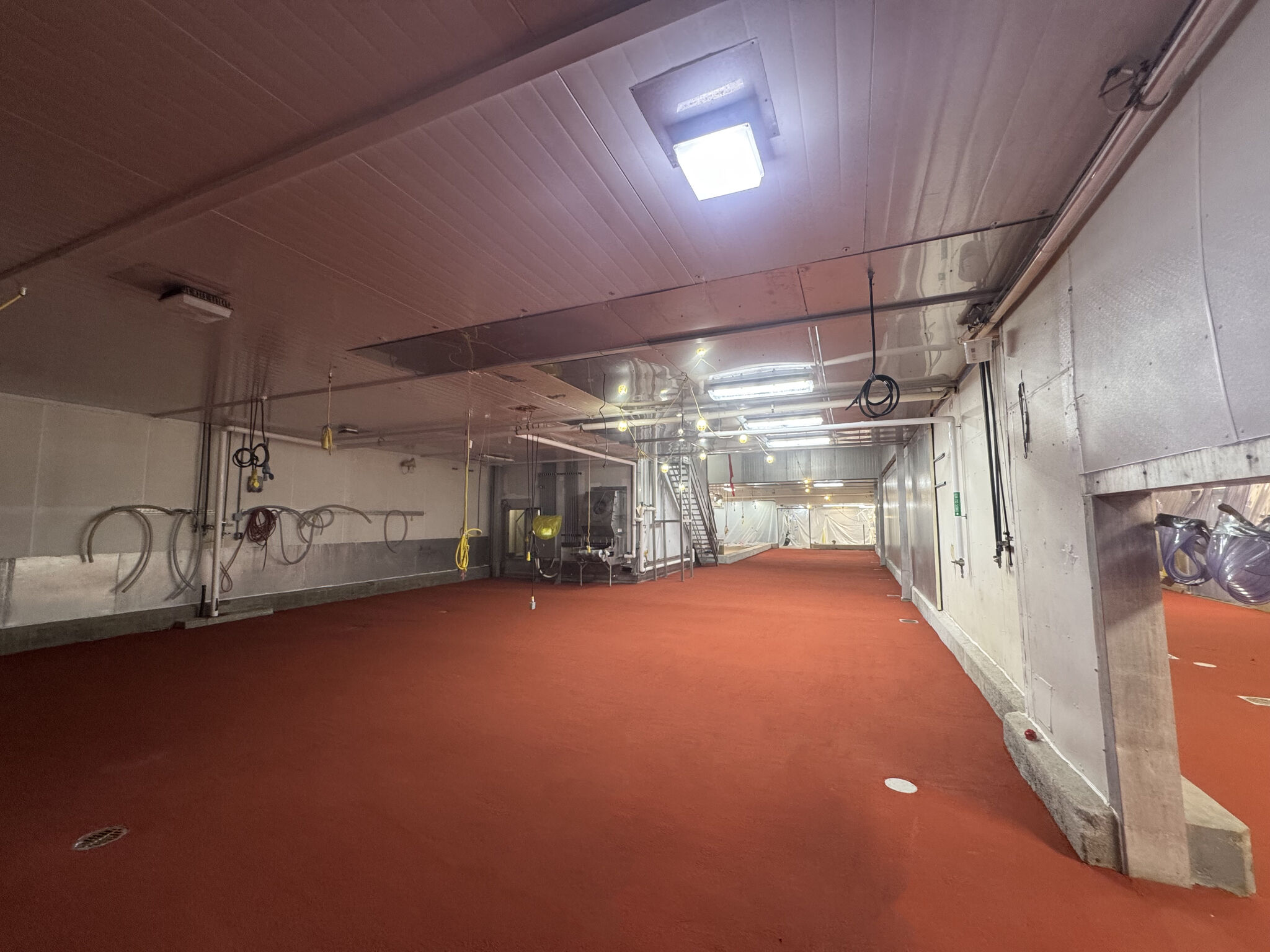 Completed 7,000 SF SaniCrete STX oven room floor installation showing seamless orange cementitious urethane flooring