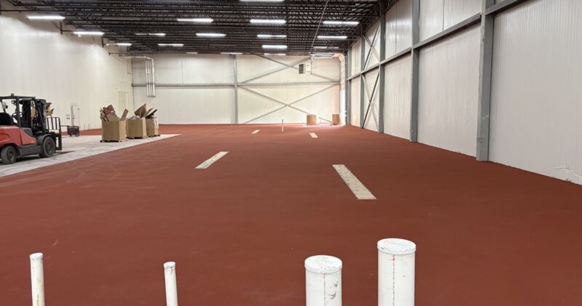 Finished red SaniCrete STX floor in a food processing expansion before equipment installation