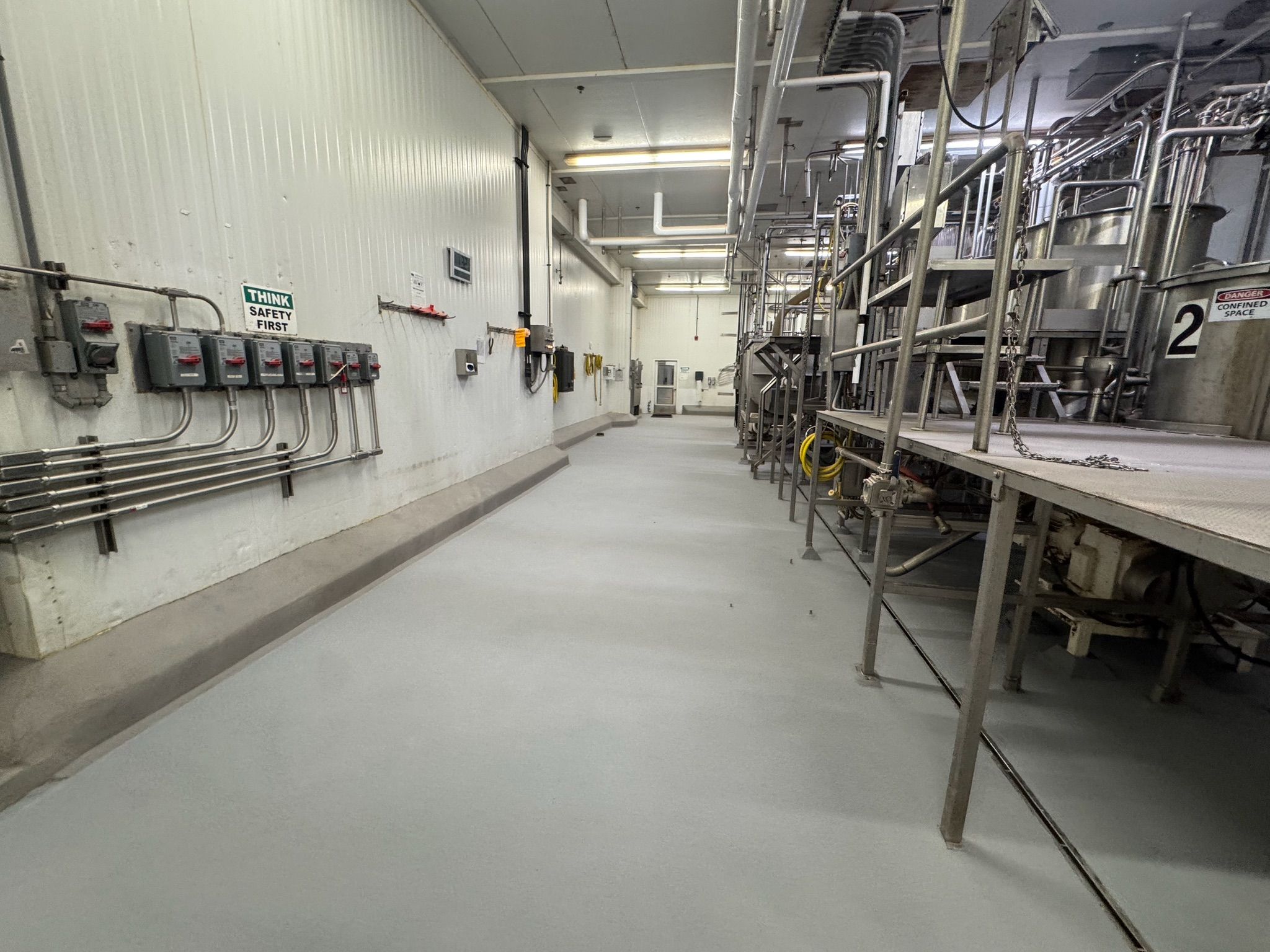 Completed seamless gray STX floor with VR curbing in processing hallway