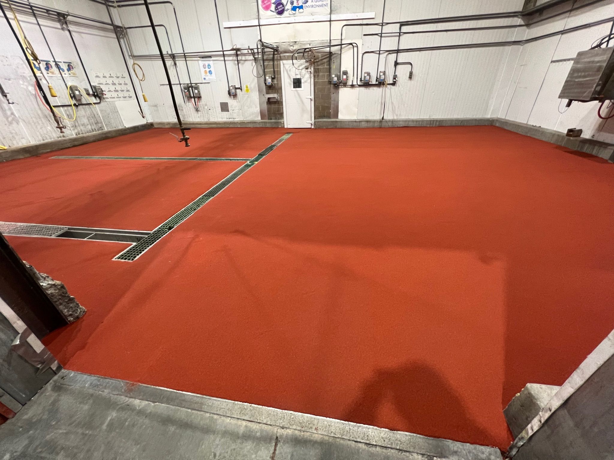 Durable 5S floor marking system integrated into SaniCrete STX resinous flooring, designed to withstand daily chemical washdowns, thermal cycling, and heavy forklift traffic in food processing plants