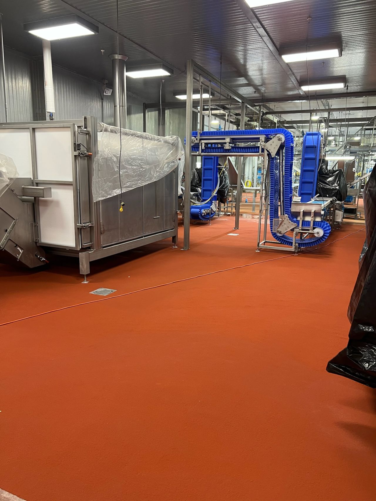 Completed red-orange SaniCrete STX floor in production area
