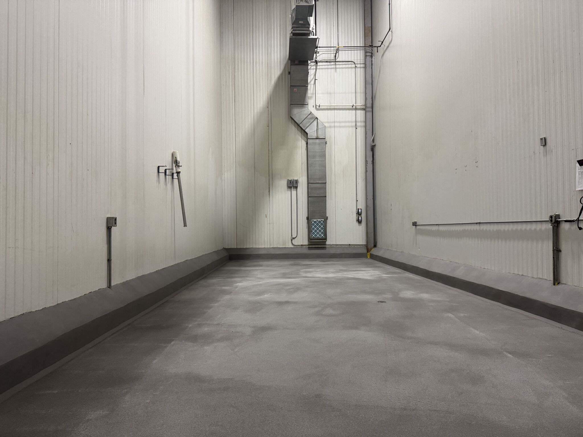 Spice room after SaniCrete STX installation — seamless floor with curbing detail